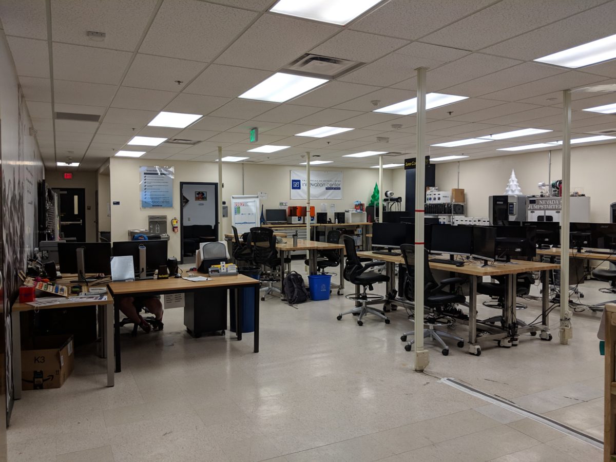 Lab environment with multiple computers, workspaces, and 3D printers.